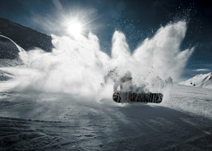 Photo by Mattias Olsson person snowboarding on mountain during daytime